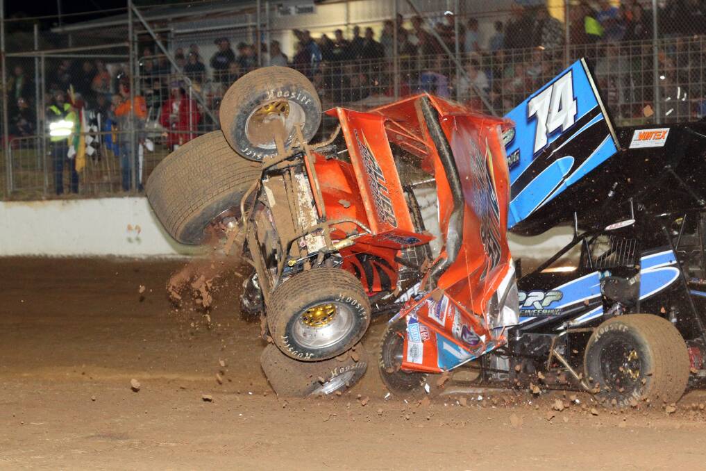 Albury driver Tony Moule crashes out at Simpson Speedway, narrowly avoiding the carnage is Kyneton driver Michael Cunningham. 