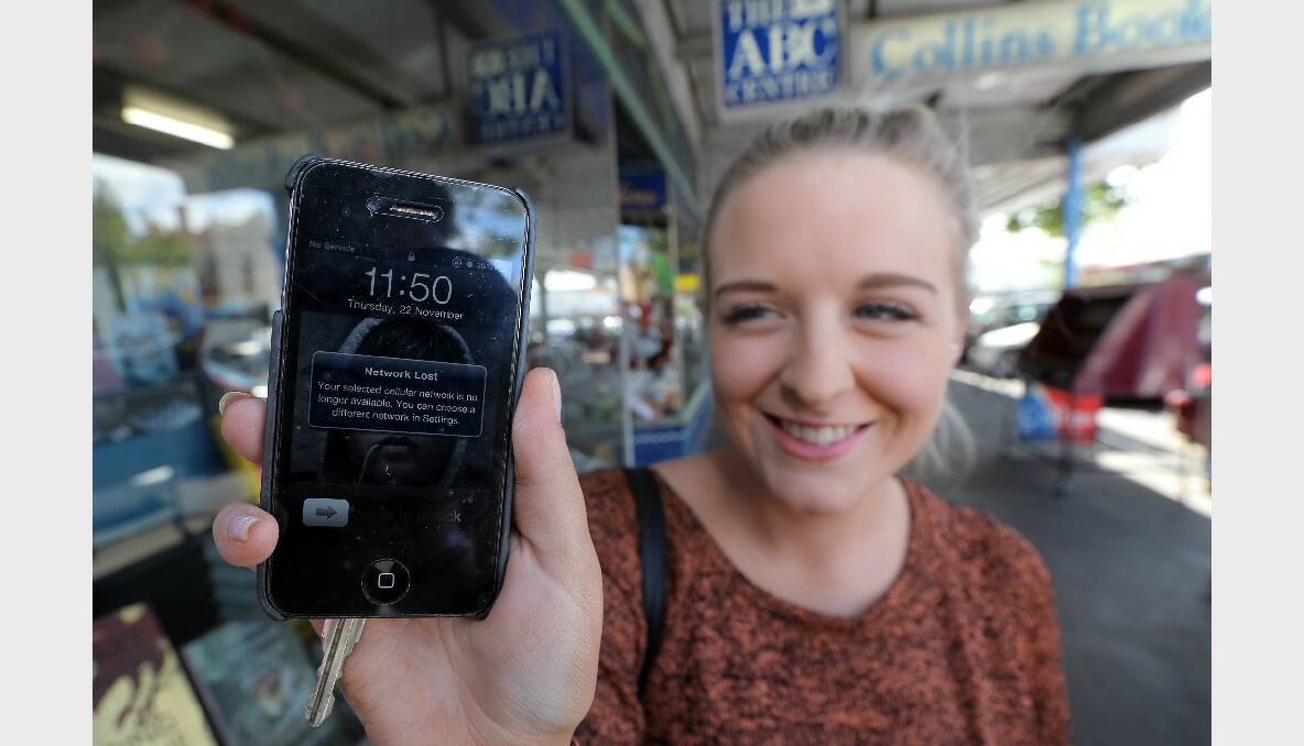 A Telstra customer shows the network outage on her iPhone.