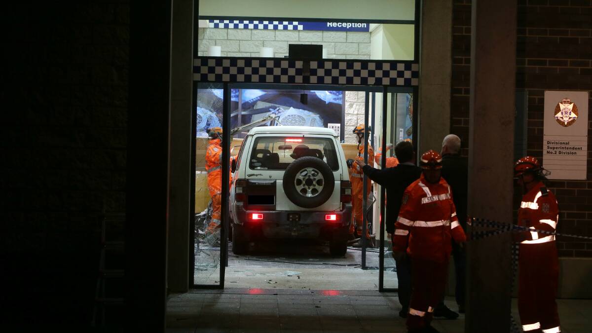The SES inspect the wreckage after a Warrnambool man drove his four-wheel drive into the Warrnambool police station.