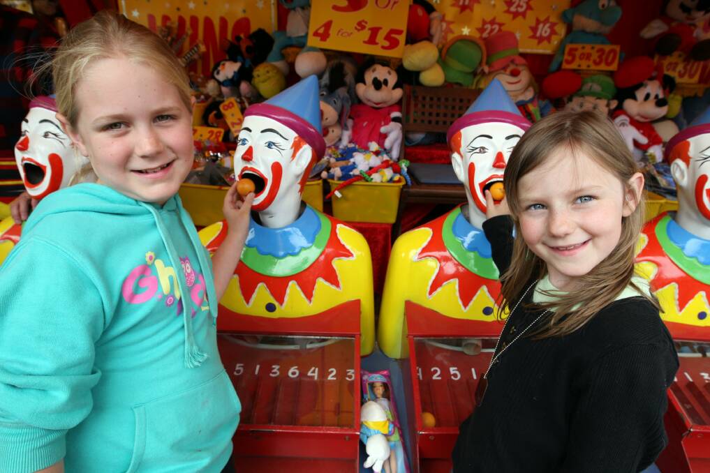 Mortlake seven-year-olds Lucy Finnerty and Letitia Howat try their luck on the laughing clowns.