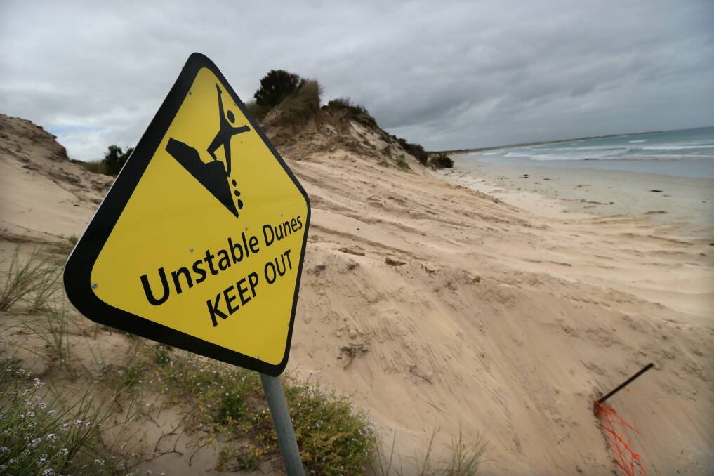 Sign of the times: a bulldozer has cleared a path from Griffith Street through an East Beach dune to allow access for rock stabilisation works in a bid to arrest erosion. 