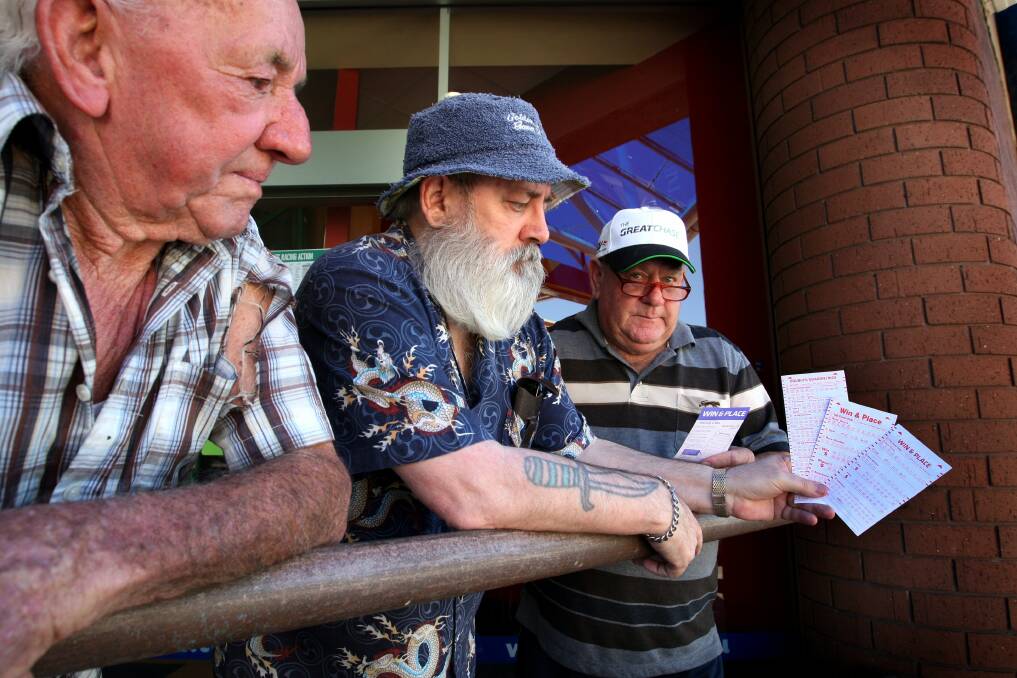 Leo Gleeson (left), Kevin Fogarty and Ray Stokes, all from Warrnambool, were having difficulty reading the new TAB betting cards.  