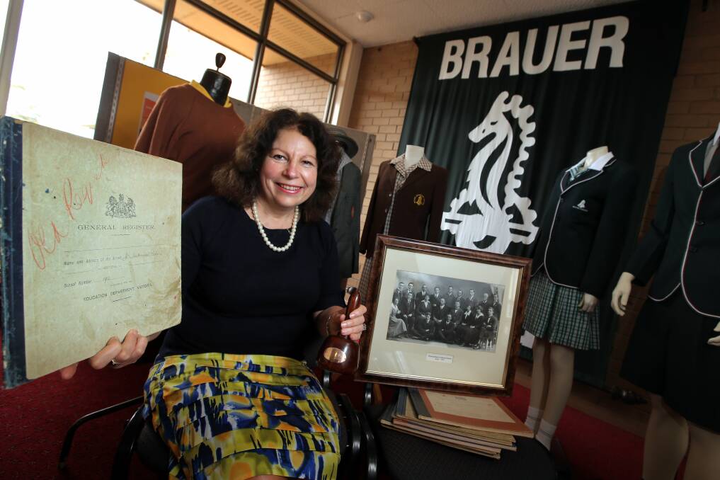 Brauer College principal Jane Boyle holds 1921 memorabilia from Warrnambool Technical School, which will form part of an historical exhibition to mark the college’s centenary this year. The celebrations will be officially launched on Friday.  