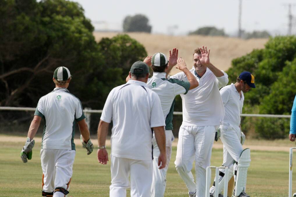  Killarney bowler Jamie Hore (right) celebrates a wicket on the opening day of the Crabs’ two-day match against Panmure Bulldogs on Saturday.    