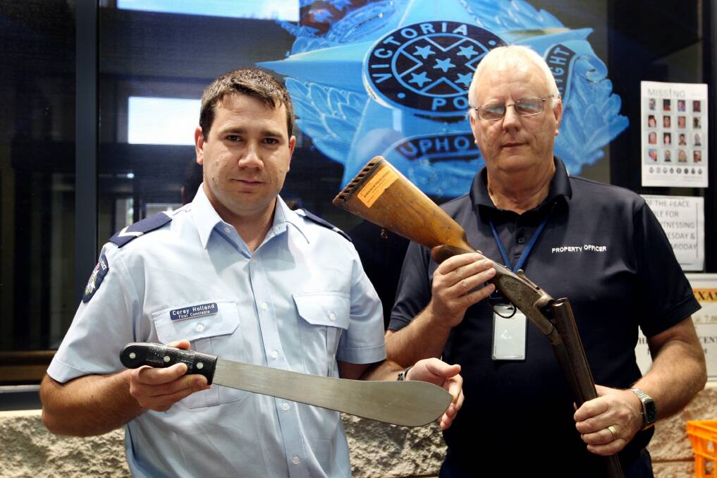 Administration and property manager at Warrnambool police station Don Wilson (right) and First Constable Corey Holland with an antique rifle and machete handed in during the ongoing weapons amnesty. 