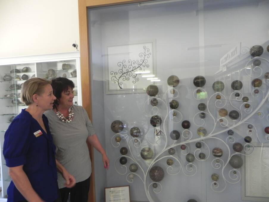 Glenelg Shire councillor Anita Rank (left) and mayor Karen Stephens inspect the Portland Cable Trams’ gemstone collection.