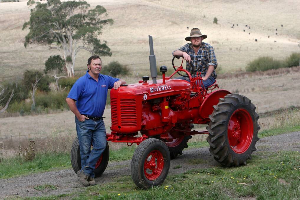Barry Edge (left) and his son Adam, of Laang, admire the restored McCormick Farmall Super A tractor.
