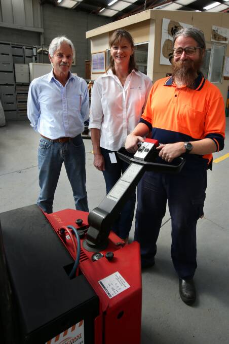 Cliff Heath (left), Kim Williams and Simon Coulson admire the new forklift at Lifeline’s warehouse. 