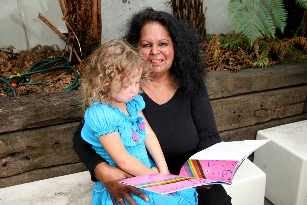 Author Fiona Clarke browses through Minkgill Chases the Rainbow with her great-niece Meekah Merriman, 4, at the launch of her first children’s book.       