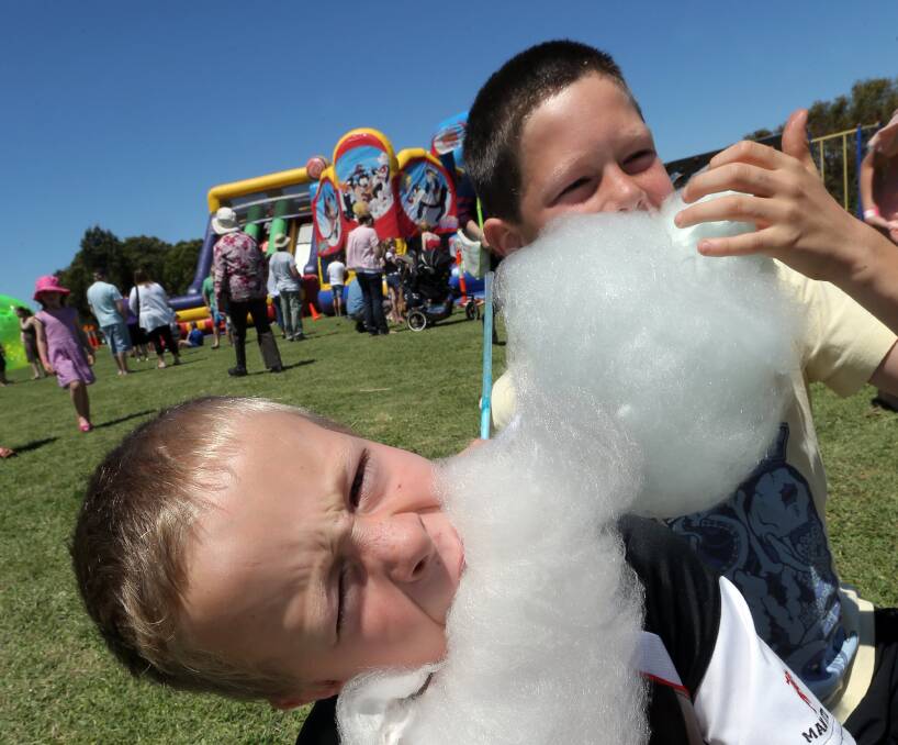 Brothers Oliver, 6, and Morgan Morland-Hunt, 9, enjoy some fairy floss at the Merrivale Fun Fair. 