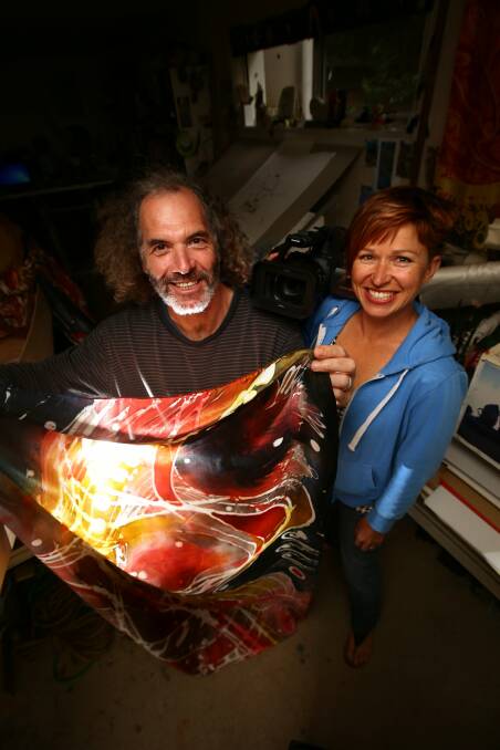 Warrnambool artist David Higgins displays one of his silk designs — the creative process recorded by filmmaker Colleen Hughson, whose short film will accompany his upcoming exhibition in Japan. 