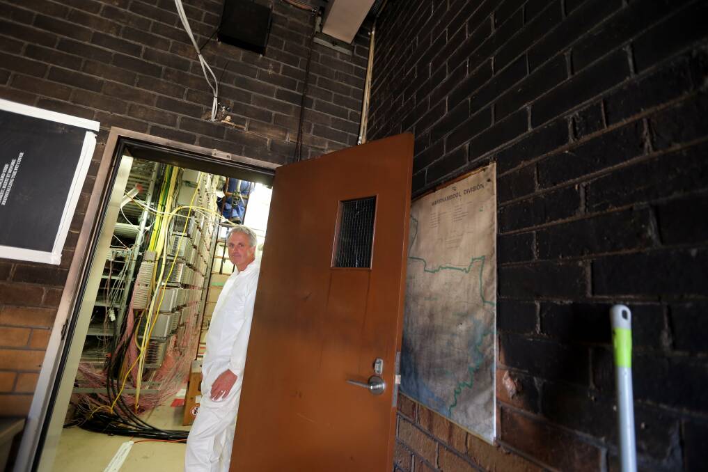 Telstra regional manager Bill Mundy at the doorway in the charred exchange building that stopped flames reaching the main distribution frame, which contained connections to about 30,000 Warrnambool properties.