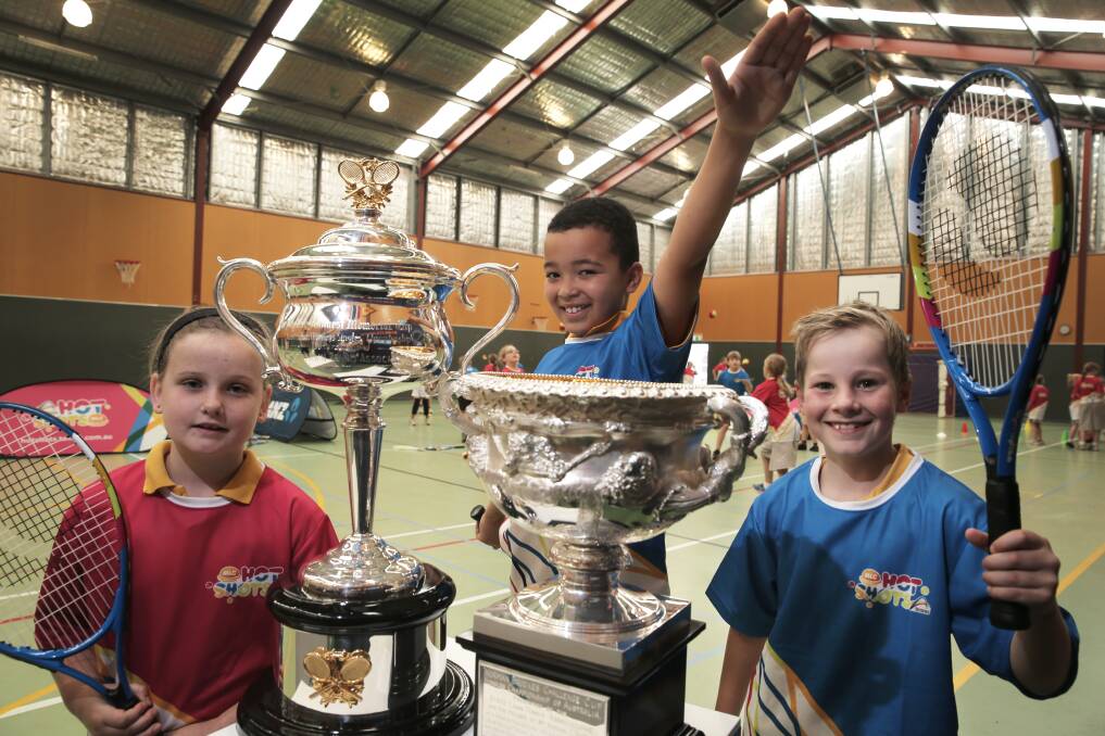  Tarliah Neave, 8 (left), Malakye Cunningham, 9, and Ethan Best, 9, from Warrnambool Primary School, get to check out the Australian Open tennis men’s and women’s trophies.