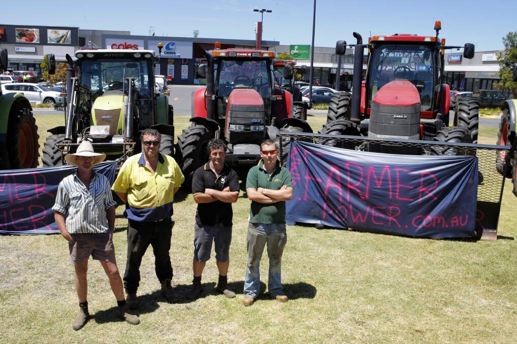 Dairy industry workers Marty McCosh (left), Nick Houston, John Houston and Darren Walsh lined their tractors outside Coles at Warrnambool’s Centro shopping centre yesterday. 