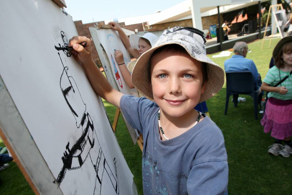 Obie Adam, 8, of Castlemaine, tries his hand at some artwork on the Civic Green. 