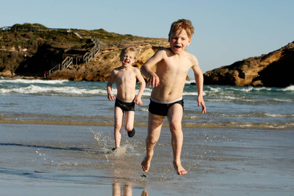 Ishmael (left), 6, and Atticus Stoneking, 8, enjoy the hot weather at Stingray Bay after living in Bristol, England, for two years. 