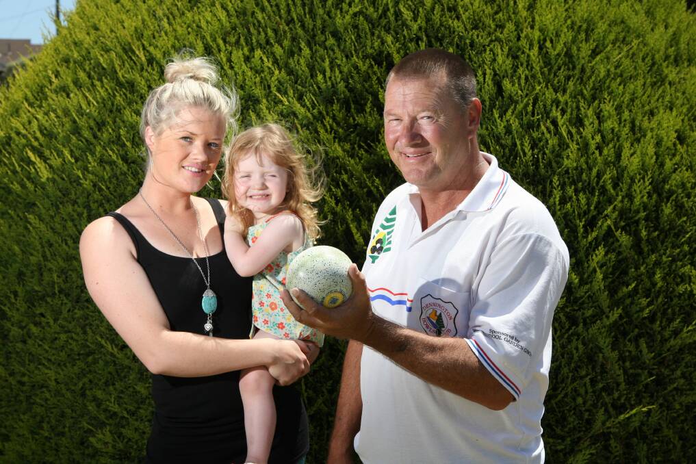 Anthony Kelly (right) with some of his precious resources: daughter Rebecca Kelly, grand-daughter Makenzie Lang, 2, and lawn bowls.