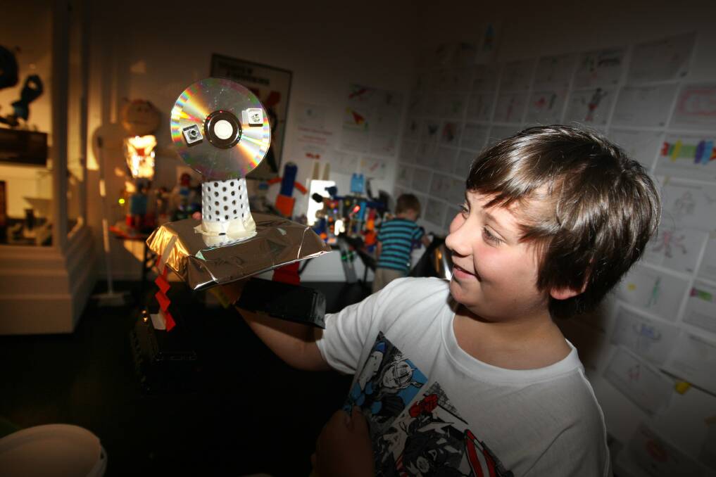 Bayleigh Robinson, 10, of Melbourne, with a robot he made as part of the Invasion exhibition at Warrnambool Art Gallery.