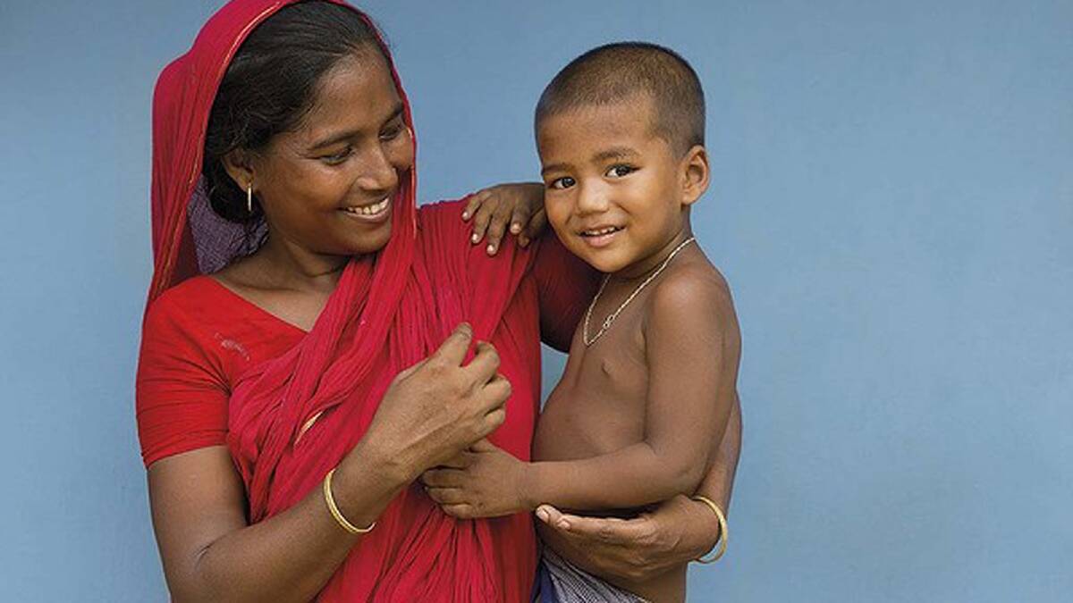 Zahira smiles fondly and with quiet pride at her three-year-old son Jahid in Satkhira, Bangladesh. Photo: Ken Duncan