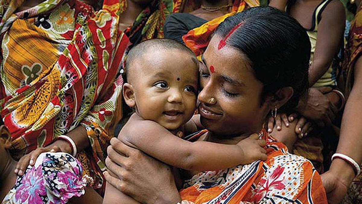 Sharifa from Bangladesh (pictured here with her son) is eight months pregnant. She has travelled to the Satkhira health clinic to receive a check up. Photo: Ken Duncan