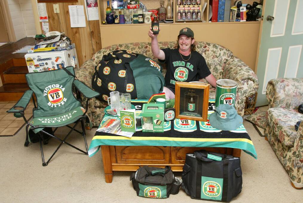 VB memorabilia collector David 'Arty' Scott  pictured in his lounge room with a few pieces from his collection.