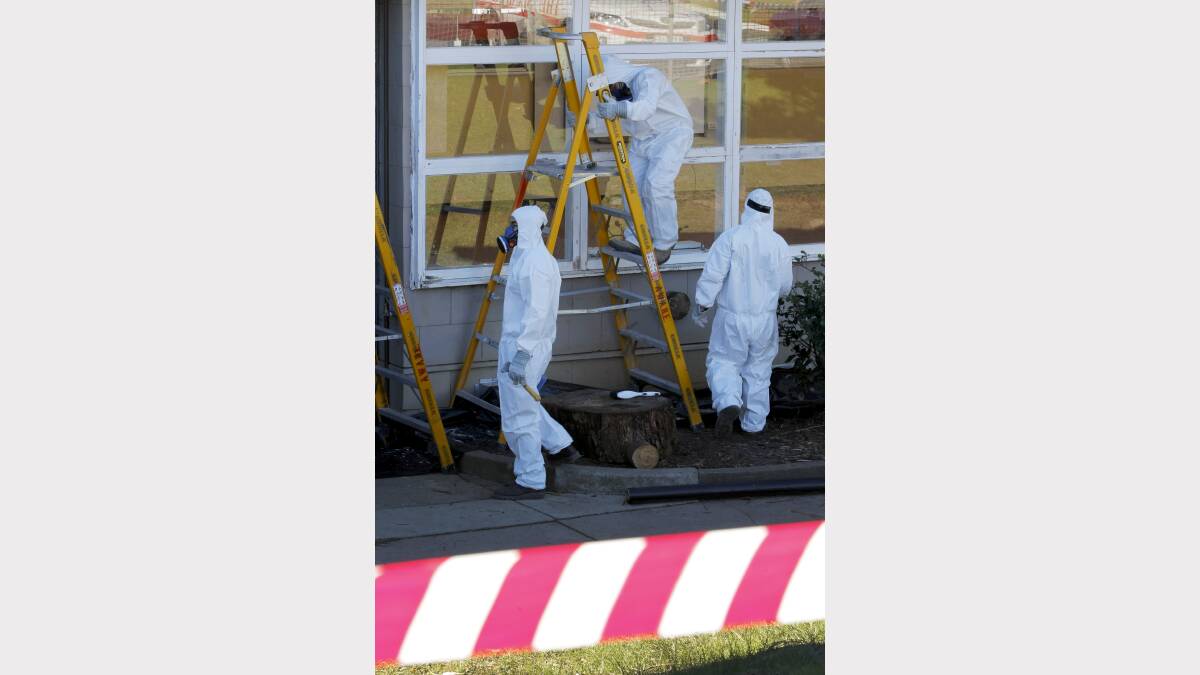 Workers clean-up lead and asbestos at Timboon P-12 yesterday.