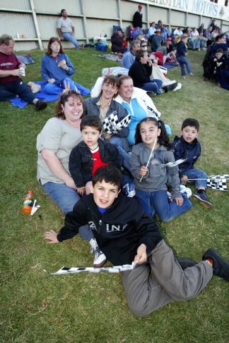 Christopher Caruana , 11,  Jake Mifsud, 5, and mum Elizabeth Mifsud (back left); Sonia Caruana and Sharon Mifsud (back middle and right); Stephanie Caruana, 9, and Nathan Mifsud, 2, (far right) take in the speedway action.