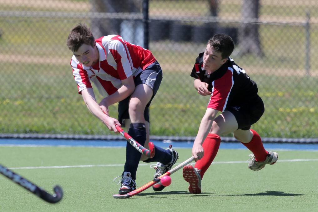 Connor Drummond drives the ball past the stick of Tom Bunge at the South West Games' Under 15 Hockey, Warrnambool vs Glenelg.  Picture: ROB GUNSTONE