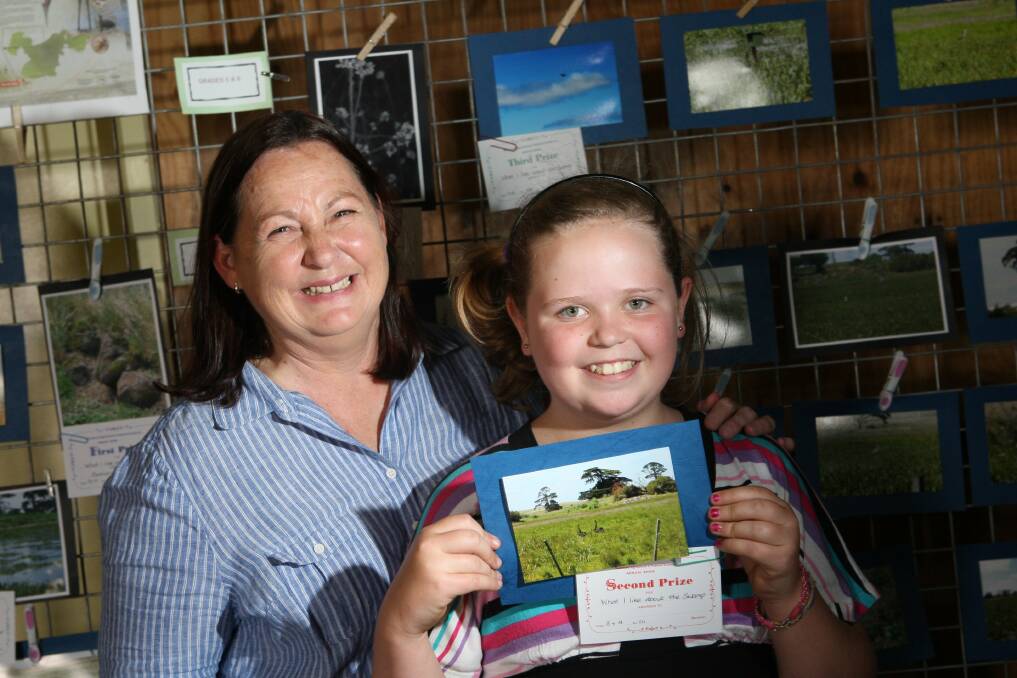 Shannon Kelly, 10, won second place in the "What I like about the swamp" photography competition, pictured with Mary Johnson from the Friends of Yatmerone Wildlife Reserve. 