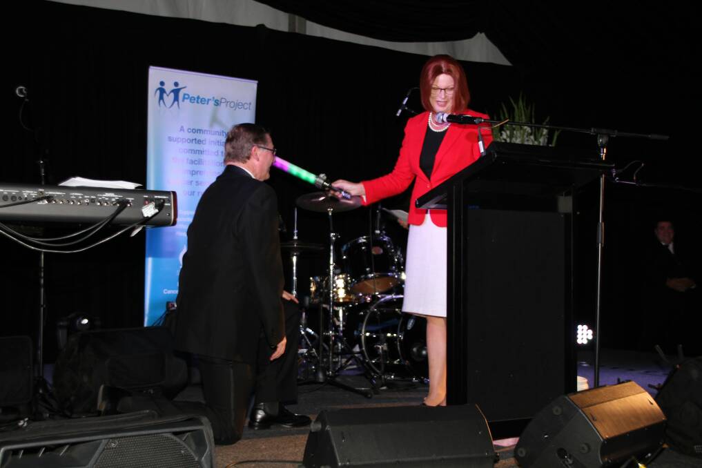 "Julia" knights "Sir Doctor Denis Napthine" on stage. PHOTO: Les Lockland.