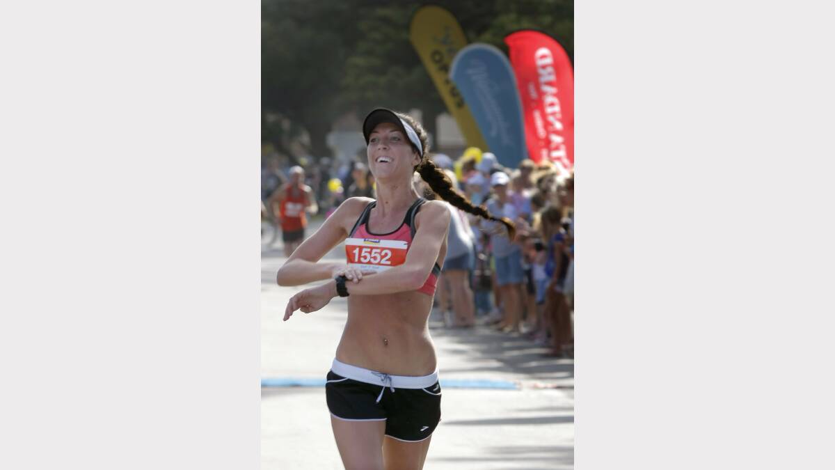 Ella Gill, of Warrnambool, is all smiles as she crosses the finish line to win the womens 10km event.