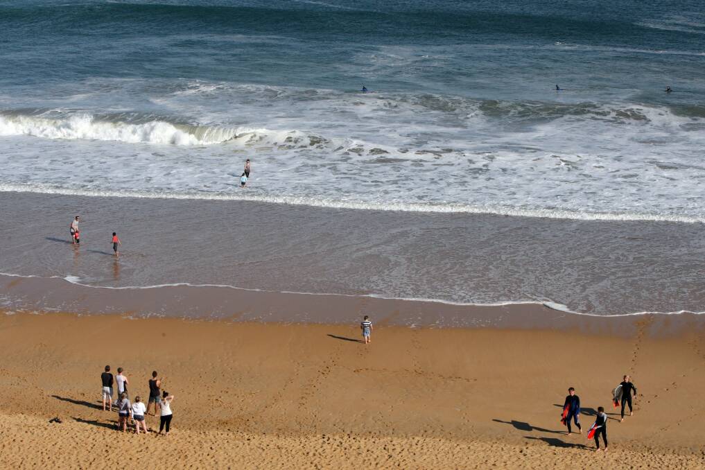 People enjoying the fine weather at Logans Beach. Picture: DAVE LANGLEY