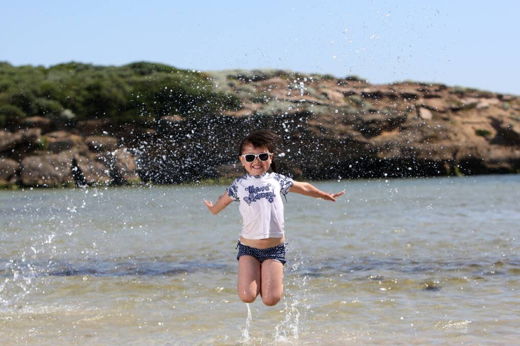 Bianca Xu, 5, from Melbourne splashes in the water at Stingray Bay.