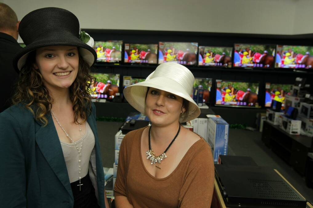 Krystal McNair and Lauren Taylor, both of Warrnambool, stop at Lehy's Electricals to watch the running of the Melbourne Cup on the various screens. 