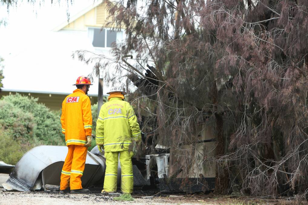Fire investigators survey the damage at the Dunkeld Conference Centre, at the rear of the Royal Mail Hotel, yesterday. 