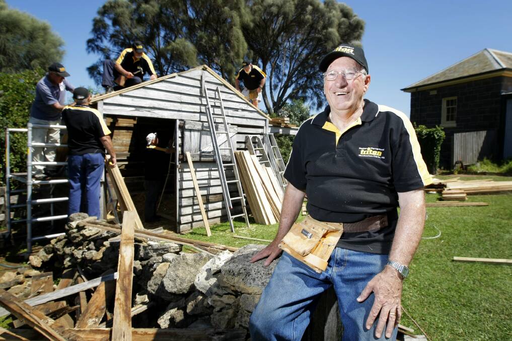 Warrnambool Triton Woodworkers president Len Byron (front), with Triton members working to give the Flagstaff Hill sheep shed a new roof.