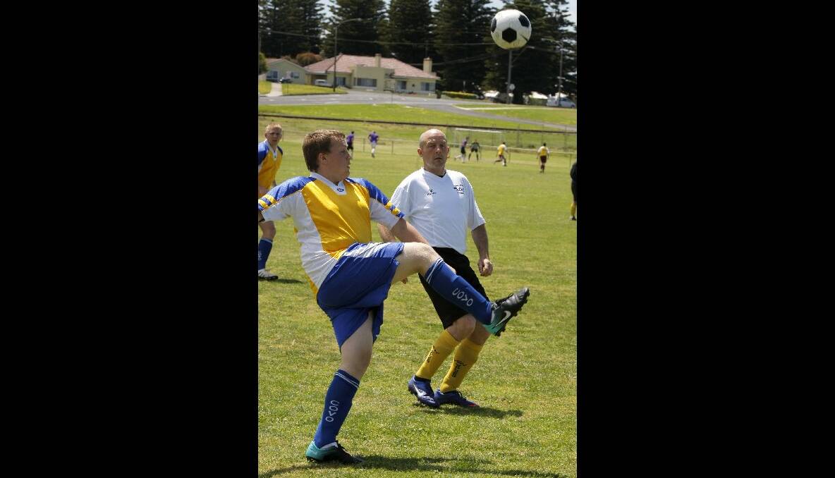Horsham player Travis McClurg chips the ball over Warrnambool player Jeff Morland, during the South West Games soccer tournament. 