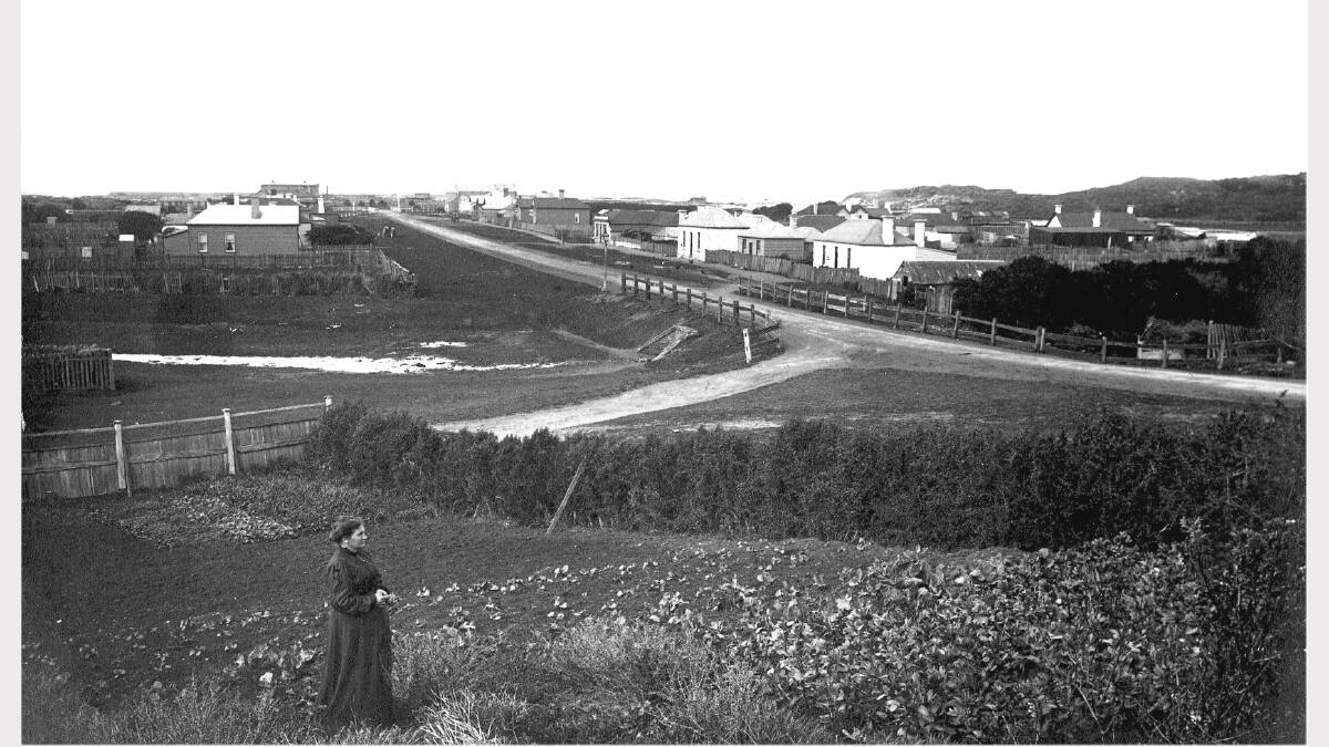 An 1890s woman in her veggie patch on Stanley Street, with Pickering Point visible on the right. SOURCE: Warrnambool & District Historical Society.
