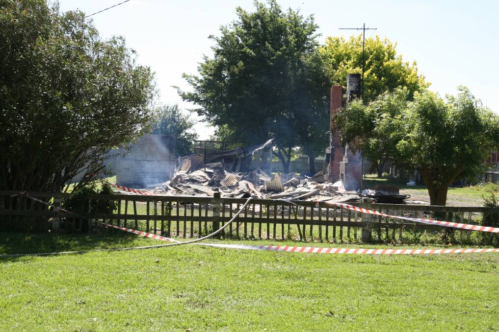Smoke wafts from the remains of the destroyed home yesterday.
