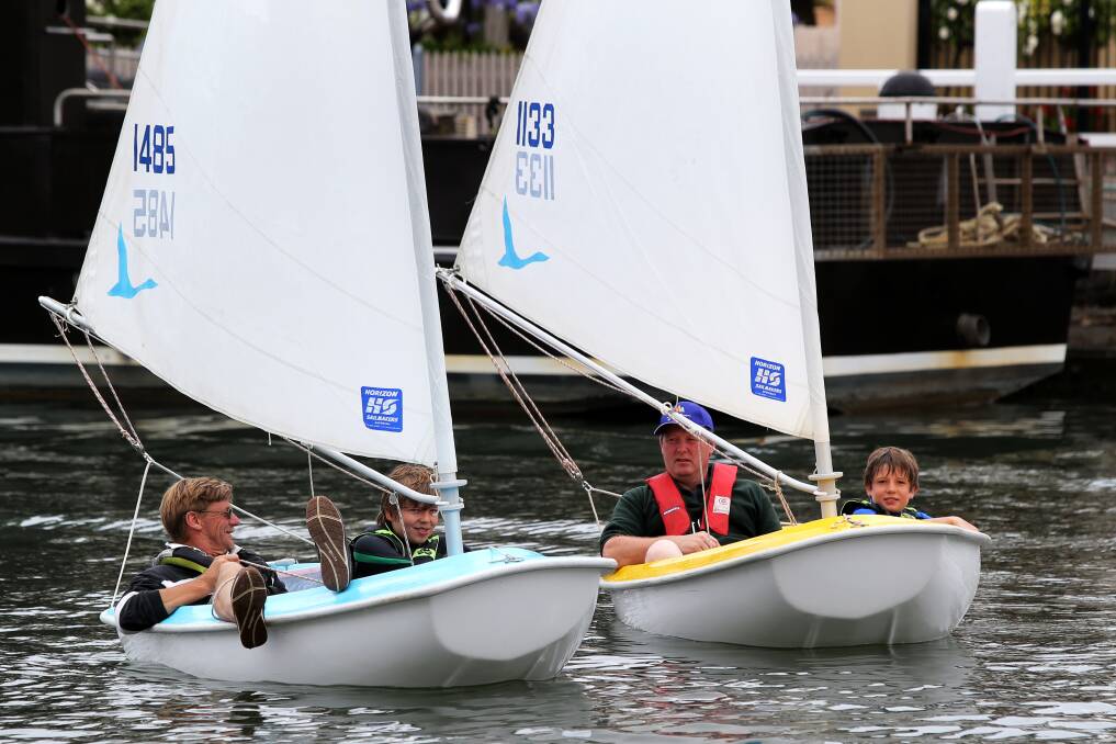 Darrel Cairns, of Port Fairy (left), William Taylor, 13, of Melbourne, David Massey, of Port Fairy, and Lachlan Jackson, 10, of Melbourne, have a go at sailing on the Moyne River.