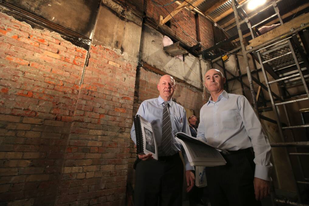 Telstra's director of network engineering David Plitz (left) and chief operating officer Brendon Riley with copies of the company's report into last November's exchange fire, in the room where the fire is believed to have started.