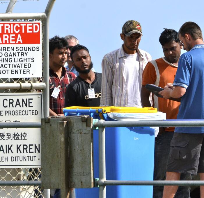 Illegal arrivals loading off the Oceanic Protector after it was involved in a stand off with the Indonesian government in Novmeber. Eventually the boat was brought to Christmas Island.  