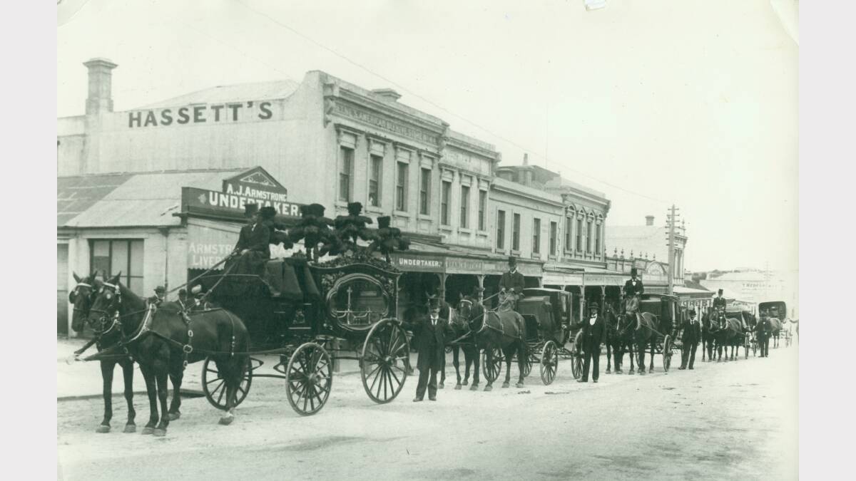 The Warrnambool undertaker's carriage pictured outside A.J Armstrong Undertaker on Timor Street. The line of buildings is now the site of Swinton's IGA. Date unknown.
