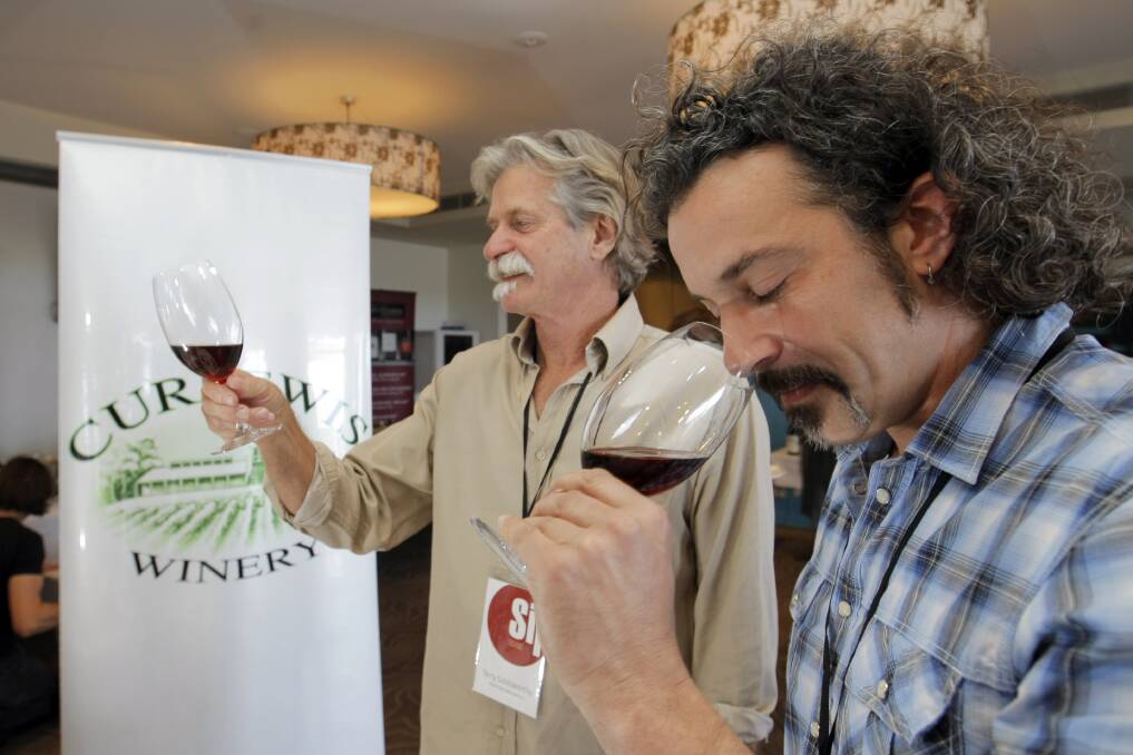 Organiser Terry Goldsworthy, red+white and Mezzanine, and Steve Curlewis, Curlewis Wines, examine some of the product at the Sip Trade day at Lady Bay Resort. Picture: ROB GUNSTONE