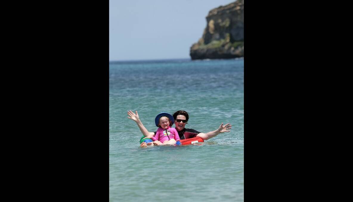 Port Campbell resident Rebecca McAuliffe with daughter Claire cooling off in the bay