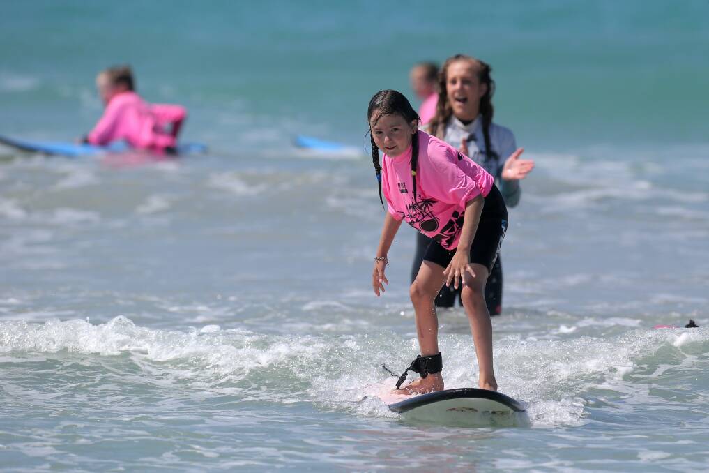 Panmure primary school pupil Karina Fitzgerald, 7, gets up with support from instructor India Payne.