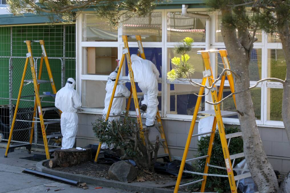 Workers clean-up lead and asbestos at Timboon P-12 yesterday.
