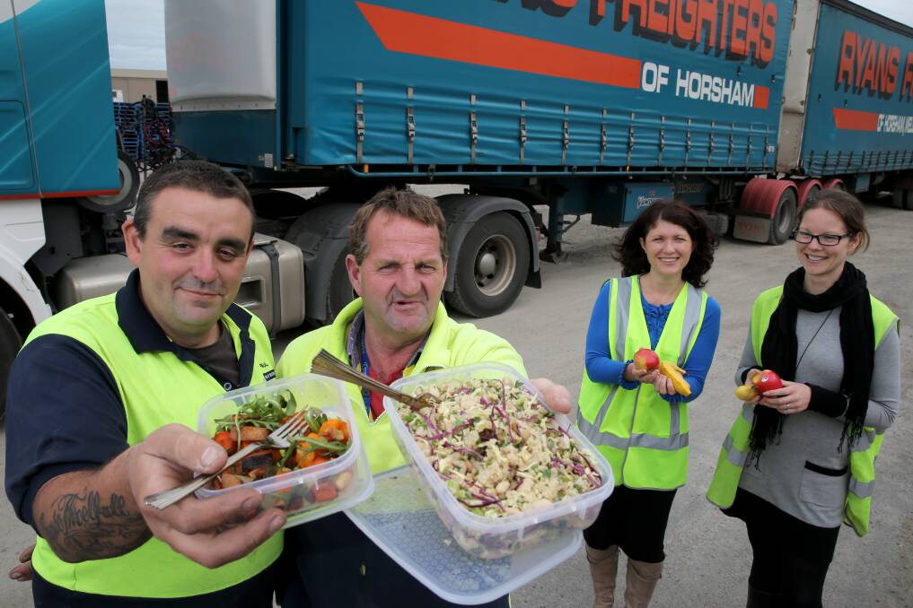 Driver Paul "Special"Brown, driver Andrew "Butch" McLean, dietitian Berni Thomas and project manager Carly Dennis, with some of the healthier lunch options for the Ryans drivers. Picture: ROB GUNSTONE
