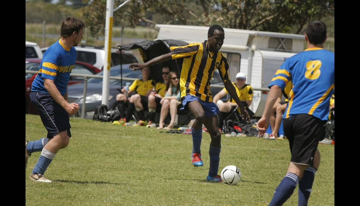 Eman Akang, from Warrnambool All Stars, looks for a way through traffic.