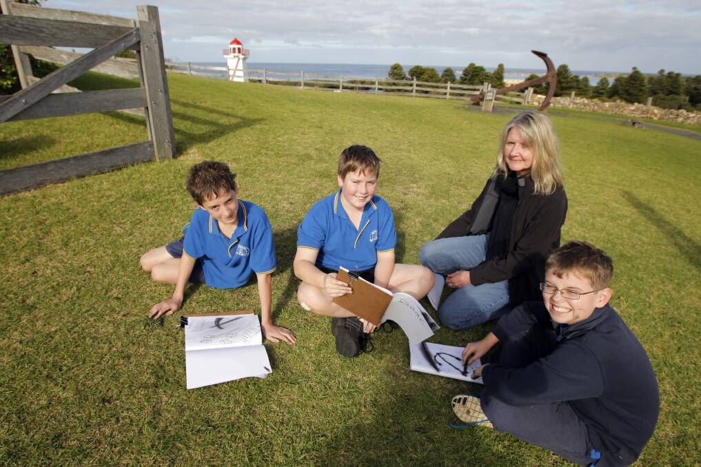 Woodford Primary School students Nick Robertson, 12,  Isaac Hussey, 11, local artist and drawing teacher Sue Ferrari, and Jye Barker, 12, work on drawings at Flagstaff Hill, as part of an Education Week Program.